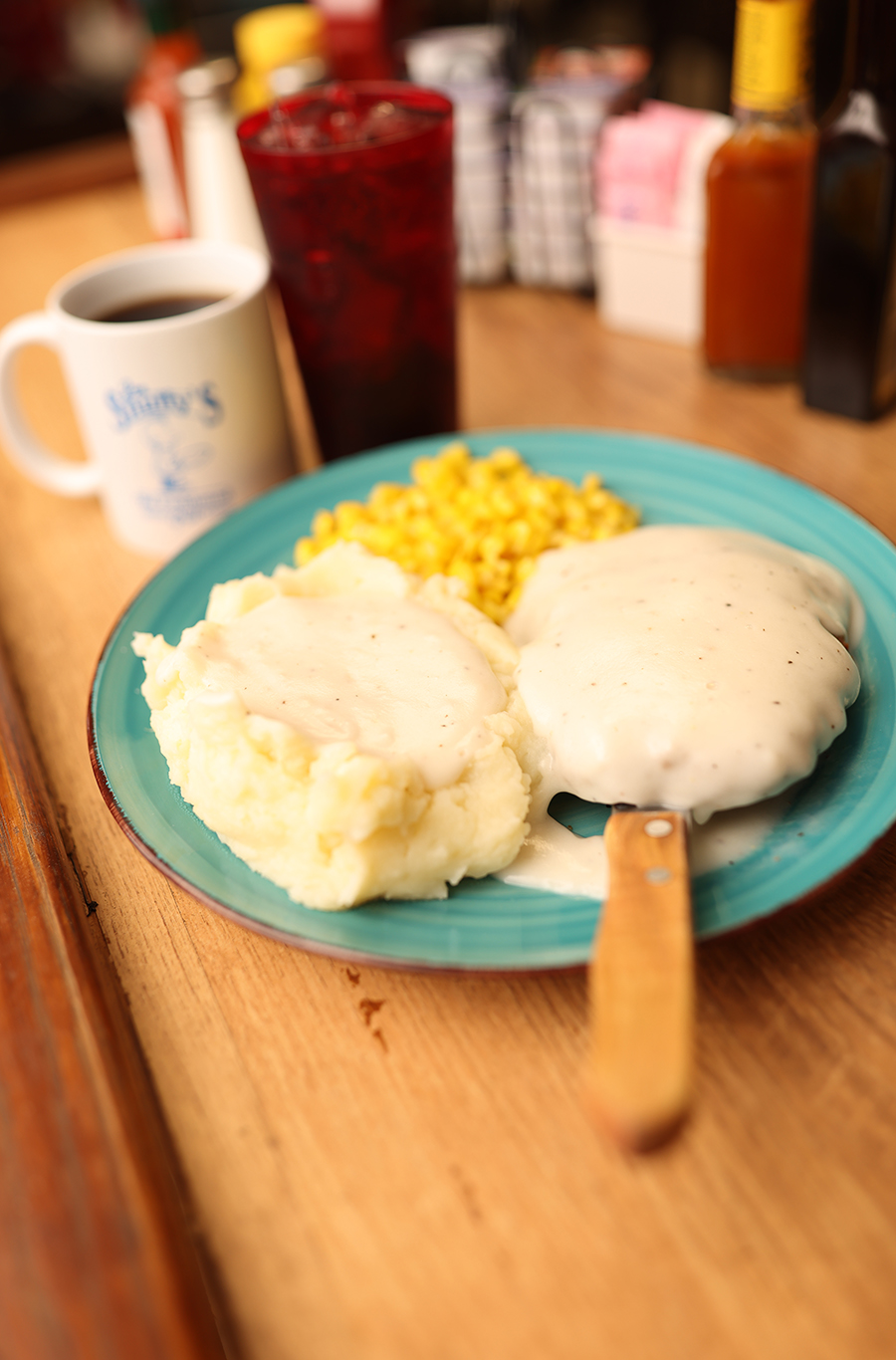 Chicken fried steak with mashed potatoes, corn, and gravy