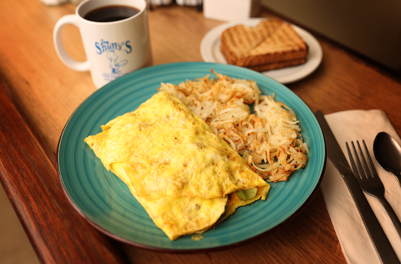 Omelette with hashbrowns, toast, and coffee