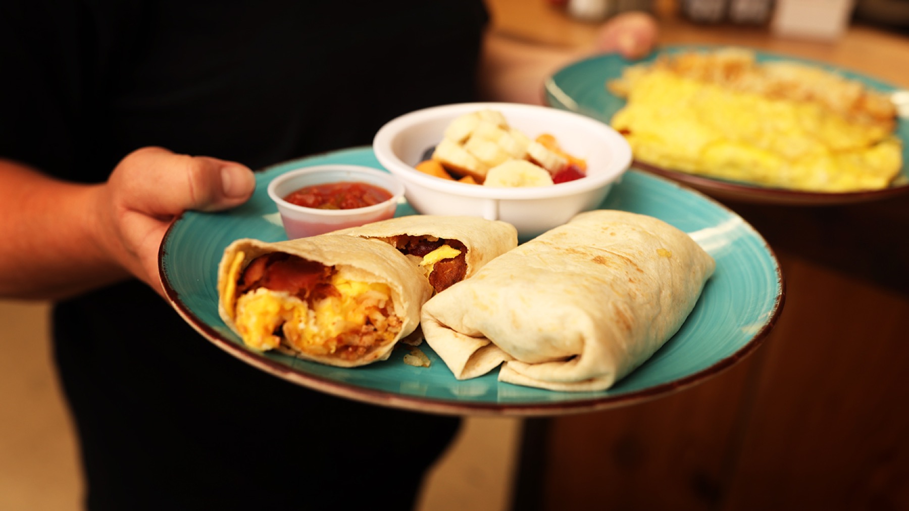 Breakfast plates being carried through Joe Snuffy's